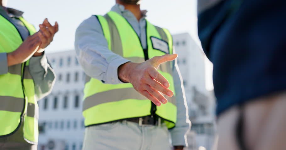 Handshake, partnership and construction team on site for building, renovation or maintenance for city planning. Contract, applause and industrial civil engineers shaking hands for project development