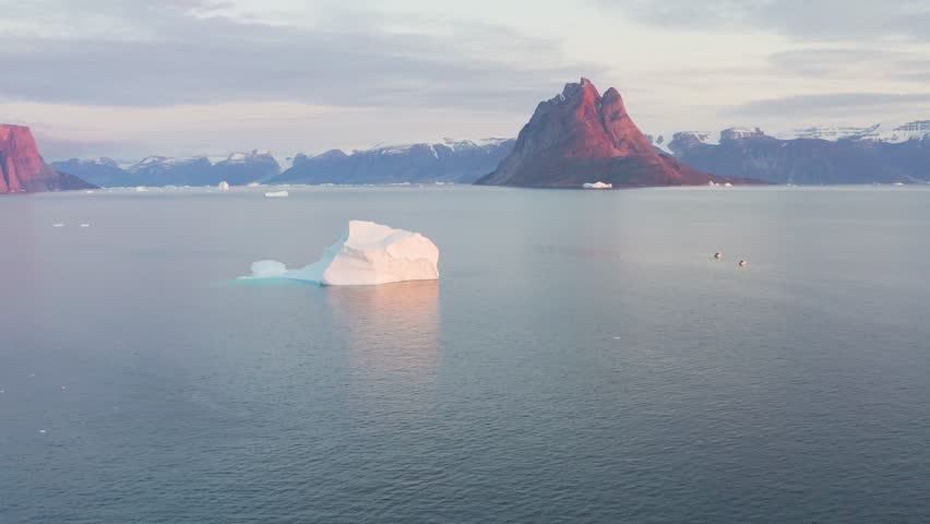 Uummannaq is the second largest city in Greenland. Is located almost 600km north of the Arctic Circle on a small island of the same name. Natural beauty of towering glacier. Climate change. Aerial