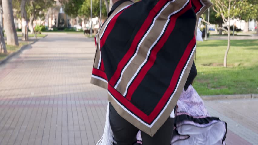 View of feet of a couple of huasos dancing cueca outside, concept of celebrating chilean national holidays