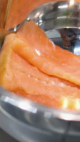 in an iron basin pieces of red fish lightly salted salmon