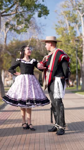 couple of huasos dancing Chilean cueca in the city square, Fiestas Patrias concept