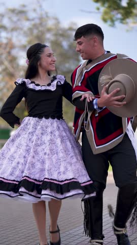 couple of huasos dancing Chilean cueca in the city square, Fiestas Patrias concept