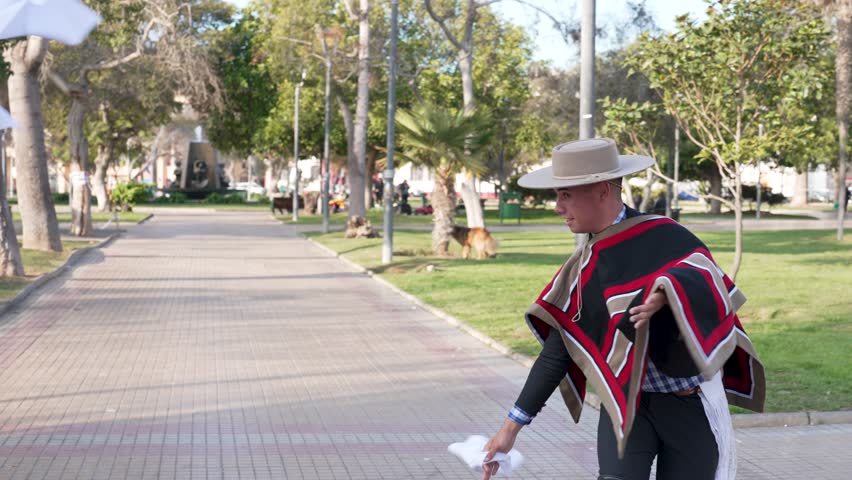 couple of huasos dancing Chilean cueca in the city square, Fiestas Patrias concept