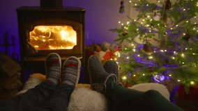 A loving couple enjoys a peaceful evening by a warm fireplace beside a beautifully decorated Christmas tree, capturing the joyous spirit of the holiday season that brings happiness to all - Powered by Shutterstock - Get 15% off with code: PIKWIZARD15