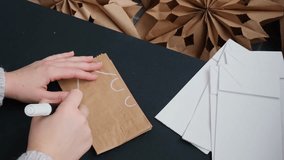 Process of preparing for Christmas star and New Year eve. 3D craft bag snowflakes DIY. Responsible ecological zero waste handmade decoration. Children hobby activity - Powered by Shutterstock - Get 15% off with code: PIKWIZARD15