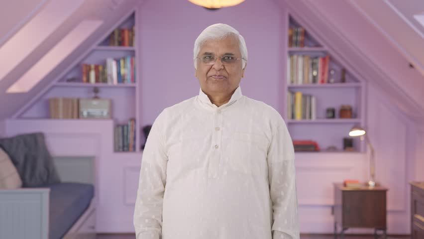 Happy Indian old man showing victory sign