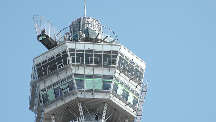 OSAKA, JAPAN - JUNE 2024 : Time lapse shot of Tsutenkaku tower in Shinsekai area. Osaka travel and tourism concept video.