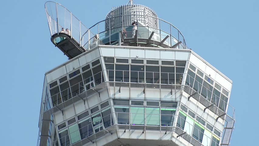 OSAKA, JAPAN - JUNE 2024 : Time lapse shot of Tsutenkaku tower in Shinsekai area. Osaka travel and tourism concept video.