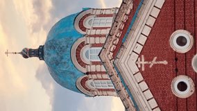 Cinematic shot of an aged, dilapidated orthodox church with a stunning blue dome against the backdrop of sunset, with birds flying over it. Vertical - Powered by Shutterstock - Get 15% off with code: PIKWIZARD15