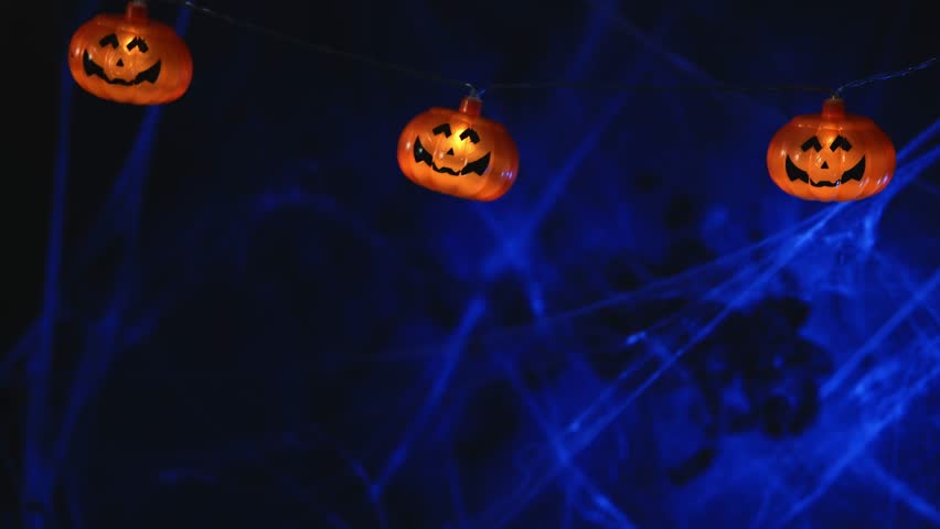 Garland with orange pumpkins on the background of cobwebs. with copy space. Halloween card background