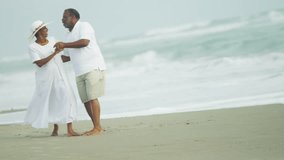 Laughing healthy retired senior couple having fun together dancing on beach Travel and Tourism - Powered by Shutterstock - Get 15% off with code: PIKWIZARD15