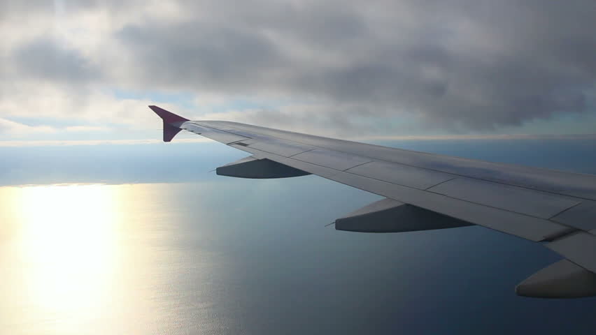 looking on wing and sea from airplane