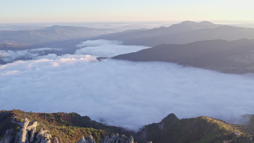 Aerial view of picturesque town with mountain backdrop and dramatic clouds, Pietrapertosa, Italy.