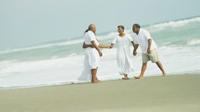 Four casually dressed senior African American friends enjoying gentle exercise walking on beach Travel and Tourism - Powered by Shutterstock - Get 15% off with code: PIKWIZARD15