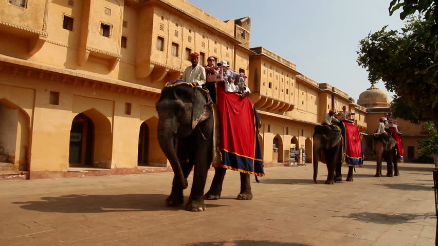 JAIPUR, INDIA - NOVEMBER 19, 2012: Tourists on elephants in fort Jaipur, India,