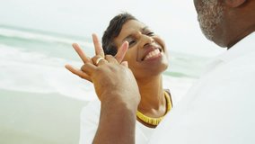Laughing retired senior couple having fun together dancing on beach Travel and Tourism - Powered by Shutterstock - Get 15% off with code: PIKWIZARD15
