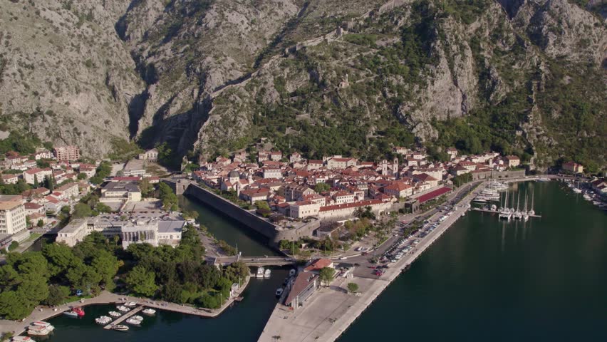 Aerial view of medieval city, bay, mountain, harbor, buildings, and water, Kotor Bay, Montenegro.