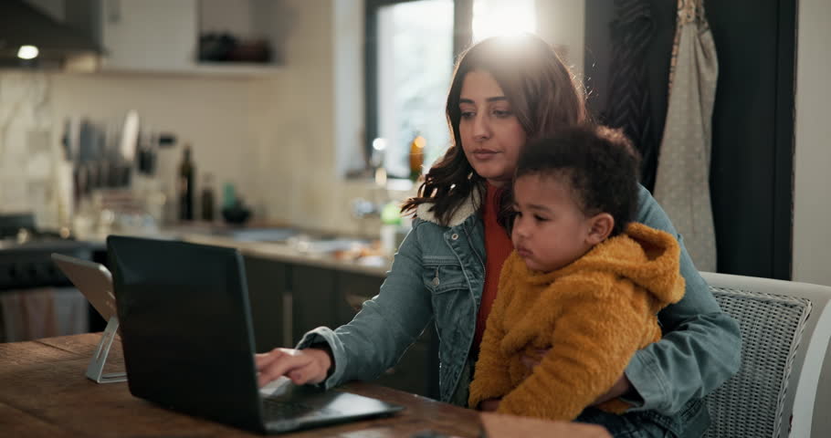Headache, remote work and mother with child in home kitchen for freelance, business and startup. Family, childcare and mom with baby by laptop for schedule stress, planning and online project anxiety