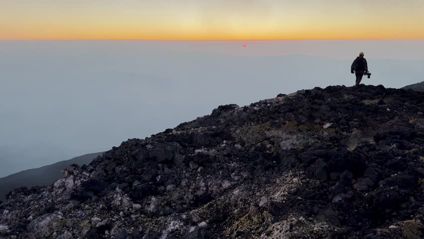 Strombolian activity from the Voragine on Etna. Explosions, lava. July 2024 Etna active on the summits. Sunset. Wells with gas emission. North East and South East Crater with Bocca Nuova.
