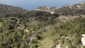 Aerial view of winding road through forest and hills, Mallorca, Spain. - Powered by Shutterstock - Get 15% off with code: PIKWIZARD15
