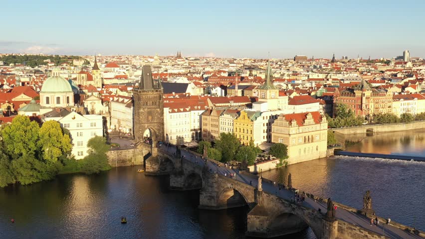 Prague Old Town in Czech Republic with Famous Sightseeing Places in Background. Charles Bridge Iconic 14th century Structure with View, Vltava river and Prague Cityscape. Must Visit City. Drone, 4k