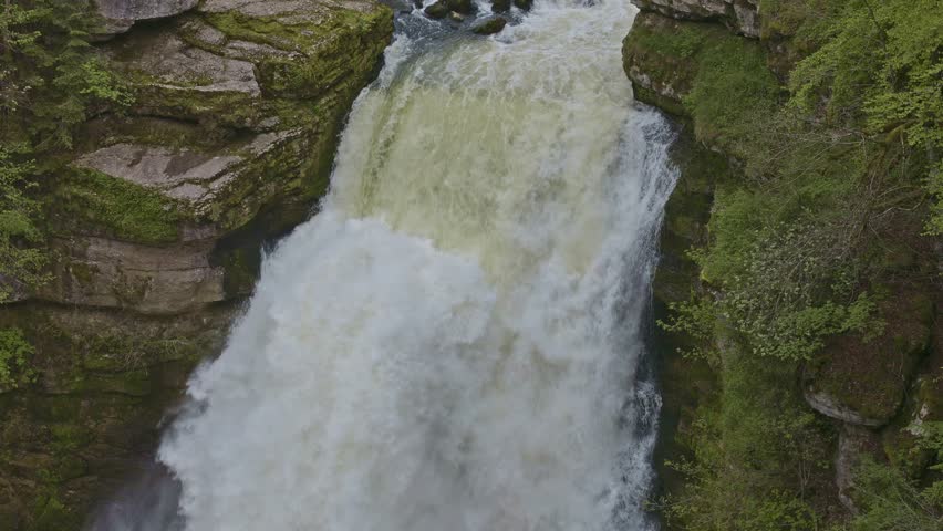 Waterfall in the mountains. Water falls from the rocks high in the mountains. Doubs Falls, Saut du Doubs, Canton Neuchatel, Switzerland.