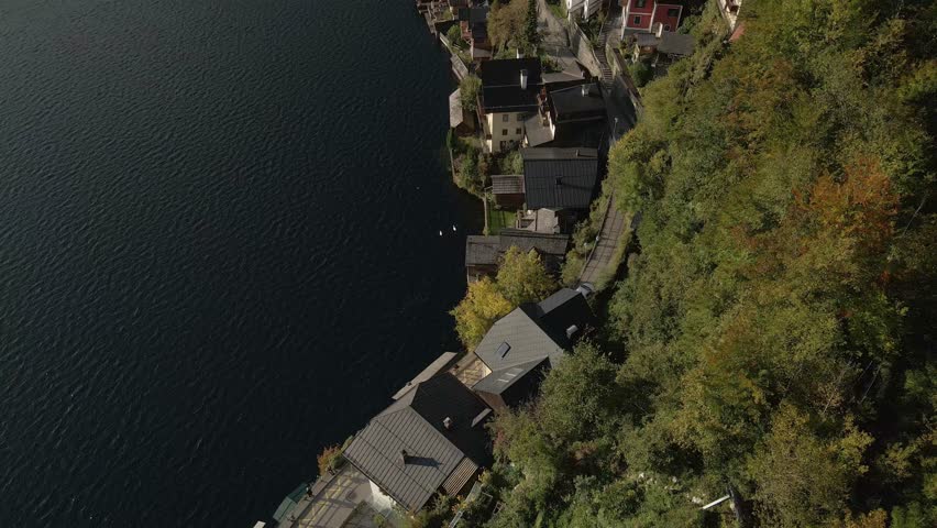 Aerial view of snowy Hallstatt town and Hallstattersee lake at sunrise, Upper Austria, Austria.