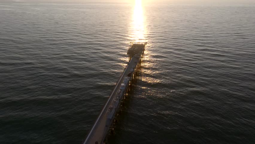 Overhead view of Scripps Pier in La Jolla San Diego California during sunset over the Pacific Ocean