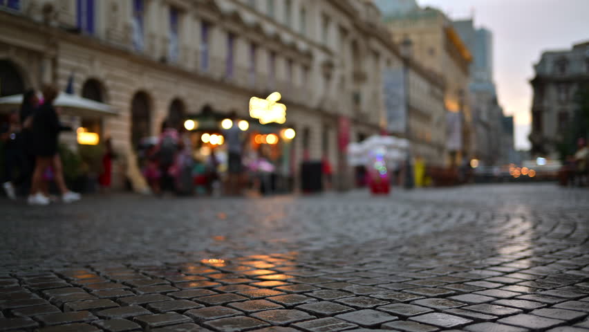 Blurred view of people walking through the Old Town of Bucharest, Romania