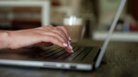Close-up hands of unrecognizable businesswoman working on laptop, sipping hot coffee while typing on keyboard, sitting at table in modern coworking space with cozy atmosphere. Shooting in slow motion. - Powered by Shutterstock - Get 15% off with code: PIKWIZARD15