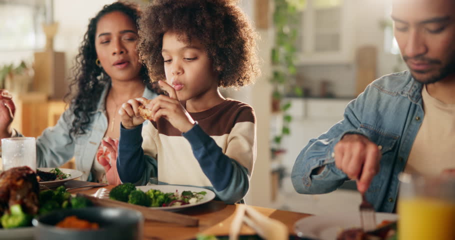 Happy family, lunch and child at table for eating, healthy meal and smile for favorite dish. Parents, kid and chicken food in home for nutrition, bonding and protein in diet with vegetables and care