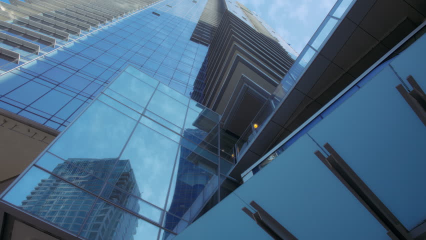 Glass facade high rise buildings in downtown Vancouver, Canada. Slow motion.