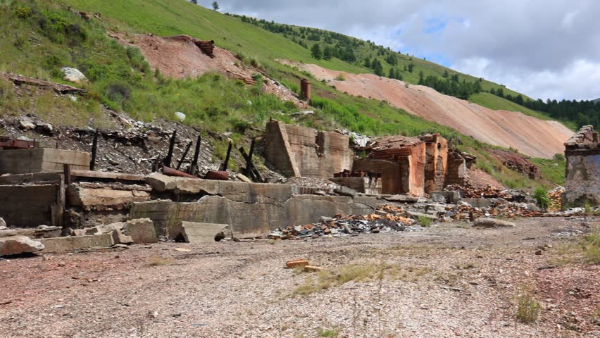 The abandoned and dilapidated buildings of a once-thriving mining town in Colorado. This image captures the feeling of desolation and decay, with the remnants of the towns former glory now in ruins.