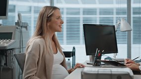 Smiling pregnant woman consulting with gynecologist during appointment closeup. Positive doctor with stethoscope taking notes writing treatment prescription. Expecting mother visit pregnancy clinic  - Powered by Shutterstock - Get 15% off with code: PIKWIZARD15