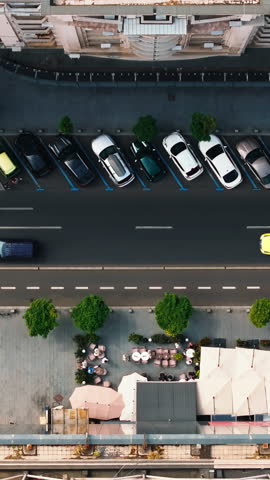 Aerial drone view of cars moving in traffic through Bucharest, Romania. Vertical