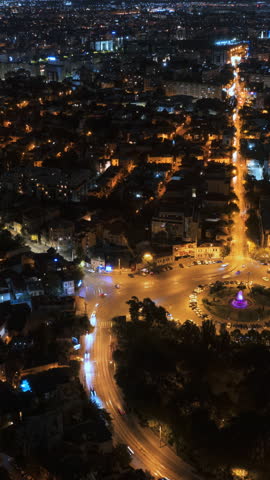 Time lapse of cars moving through Bucharest, Romania, at night. Vertical