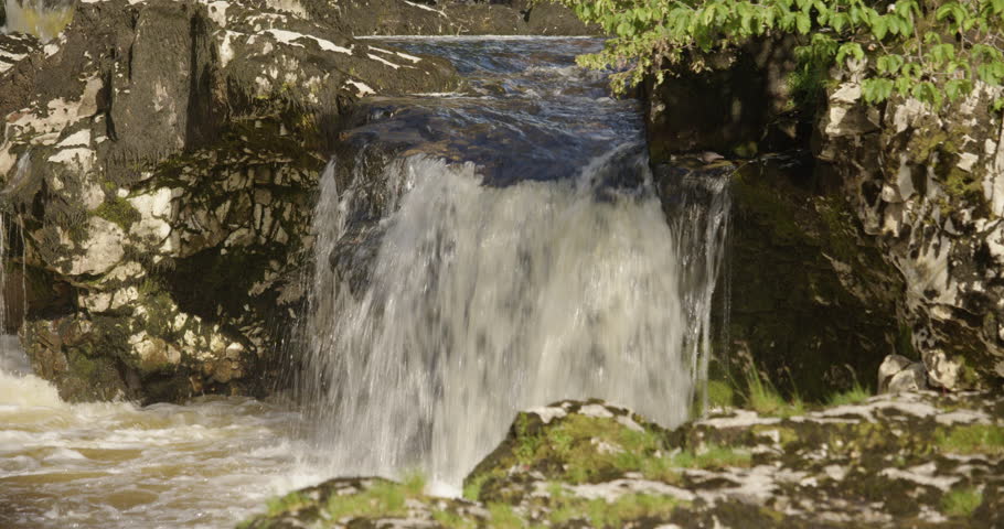 Close up shot of water going over the limestone Linton falls on the river Wharfe in the Yorkshire Dales
