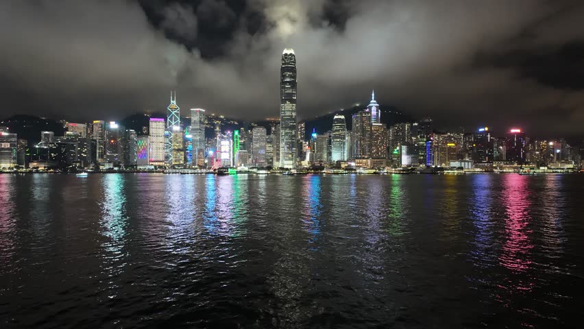 Clouds by Victoria Harbour and Hong Kong skyline at night, motionlapse