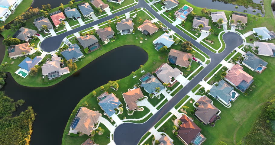 Low-density private homes at sunset. Rural street cul-de-sac dead end in residential suburbs with upscale suburban houses outside of Sarasota, Florida