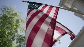 Detailed slow motion view and abstract background of the red, white, and blue American flag as it sways in the wind on a rural conservative porch on a warm, summer day in Lancaster, Ohio - Powered by Shutterstock - Get 15% off with code: PIKWIZARD15