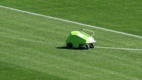 Automated line marking machine painting white lines on soccer field - Powered by Shutterstock - Get 15% off with code: PIKWIZARD15