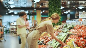 The scene at the vibrant grocery store is lively, with dedicated staff members actively assisting customers as they explore a colorful array of fresh, locally sourced produce options - Powered by Shutterstock - Get 15% off with code: PIKWIZARD15