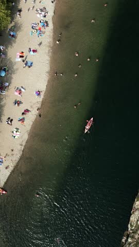 Aerial view of the river beach close to Pont du Gard aqueduct bridge. Gardon River, France, vertical video