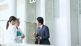 Businessman explaining to a technician in a white coat - Powered by Shutterstock - Get 15% off with code: PIKWIZARD15