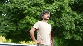 Young man enjoy peaceful moment outdoors practicing mindfulness and deep breathing exercises. Standing in nature park or forest near trees tranquility. Relaxation and meditation in serene environment - Powered by Shutterstock - Get 15% off with code: PIKWIZARD15