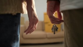 Close up shot hands of couple homeowner holding the house key and walking through inside the room with boxes and furniture background after moving to new house, relocating apartment concept.
 - Powered by Shutterstock - Get 15% off with code: PIKWIZARD15