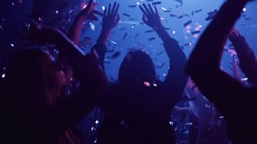 Group of friend celebrating and dancing in night club with illuminated neon night lights and falling confetti - Powered by Shutterstock - Get 15% off with code: PIKWIZARD15