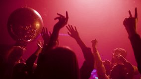 Footage of a crowd during colorful party in different clothes having fun and dancing at a midnight party. Shot in slow-motion - Powered by Shutterstock - Get 15% off with code: PIKWIZARD15