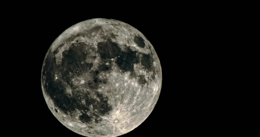 Background video close-up of the full moon moving in the night sky. Astronomy craters on the moon in moonlight. High quality 4k footage