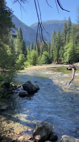 PAN SHOT - The Merced River threads through Yosemite National Park in a stretch popular for boating and whitewater rafting, in California, USA.
